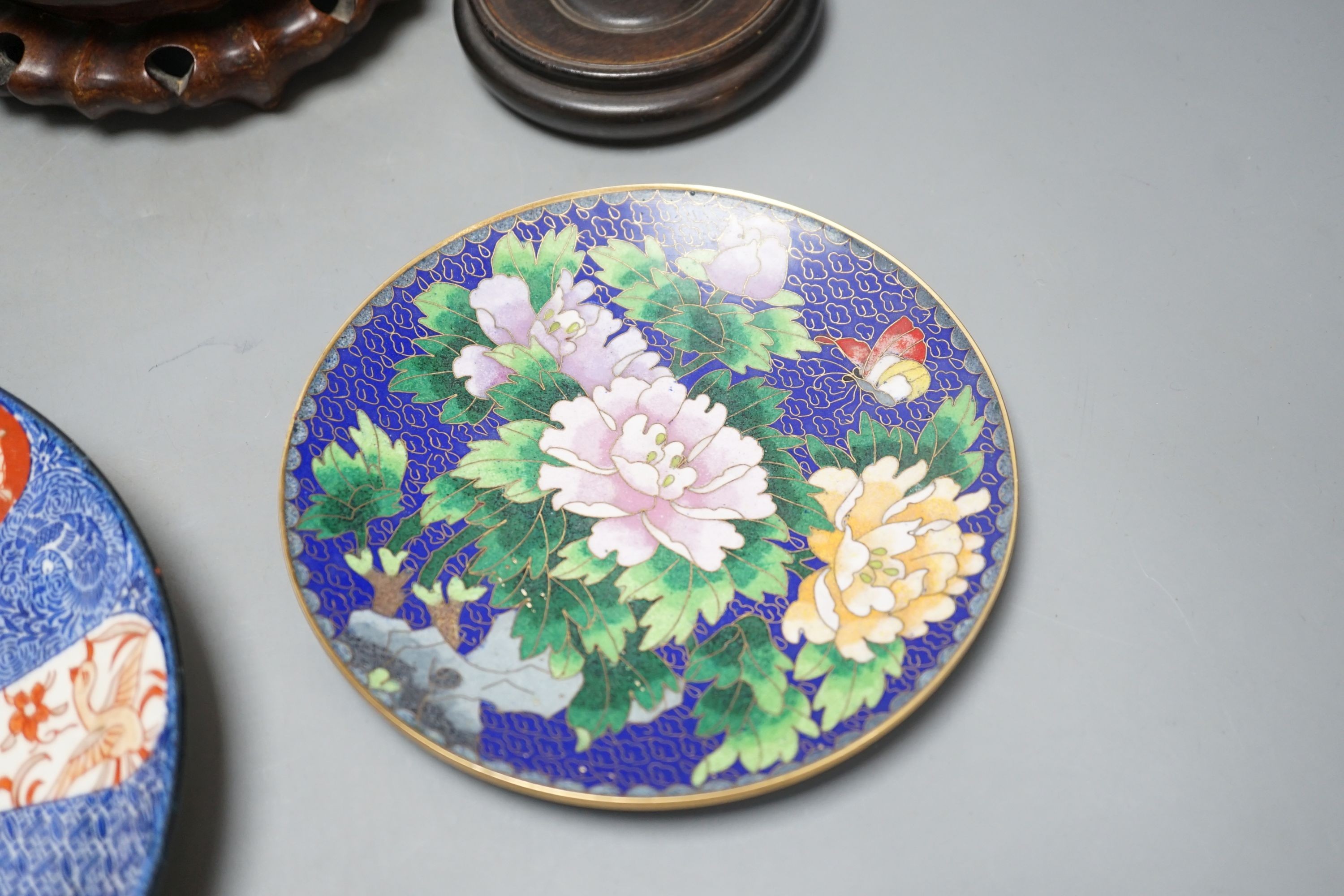 A Continental porcelain jam pot, 15cm tall, and cover with stand, together with 2 Chinese hardwood stands, enamelled plate and another (7)